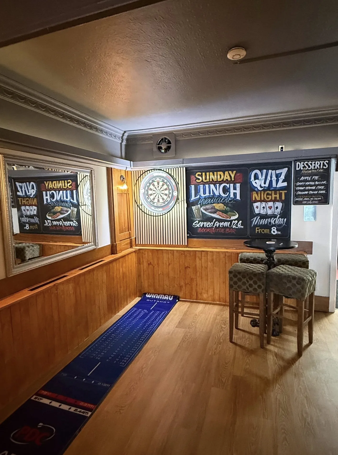 Darts corner and quiz chalkboard inside Robin Hood